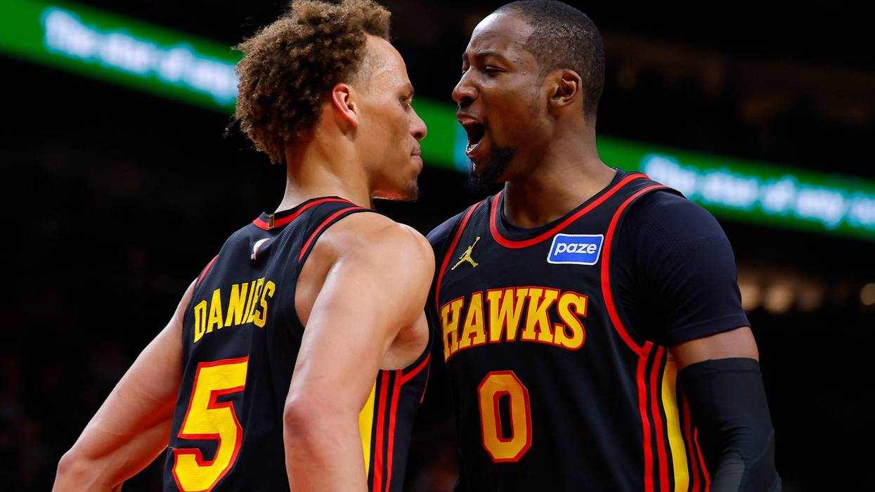 ATLANTA, GEORGIA - FEBRUARY 24: Jonathan Kuminga #0 of the Atlanta Hawks reacts with Dyson Daniels #5 during the third quarter against the Washington Wizards at State Farm Arena on February 24, 2026 in Atlanta, Georgia