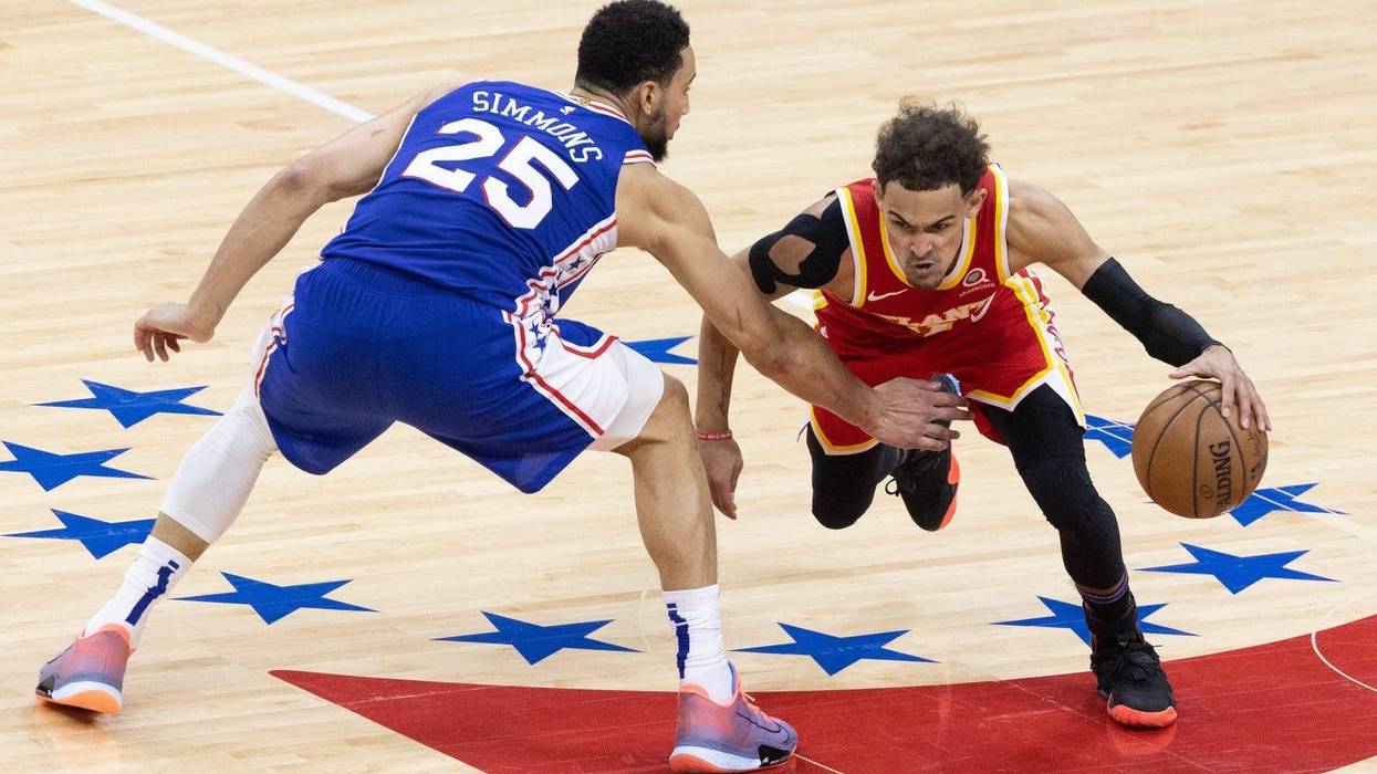 Atlanta Hawks guard Trae Young dribbles past Philadelphia 76ers guard Ben Simmons