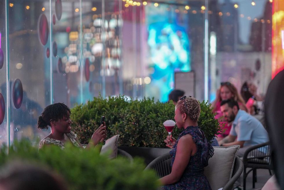 Attendees enjoying drinks at "Bubbles Over Broadway" at The Perch, on the eighth floor of the New York Marriott Marquis.