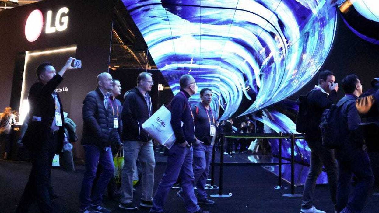 Attendees enter the LG booth under an AV display at CES 2023 at the Las Vegas Convention Center on Jan. 5, 2023 in Las Vegas, Nevada. CES, the world's largest annual consumer technology trade show, runs through Jan. 8.