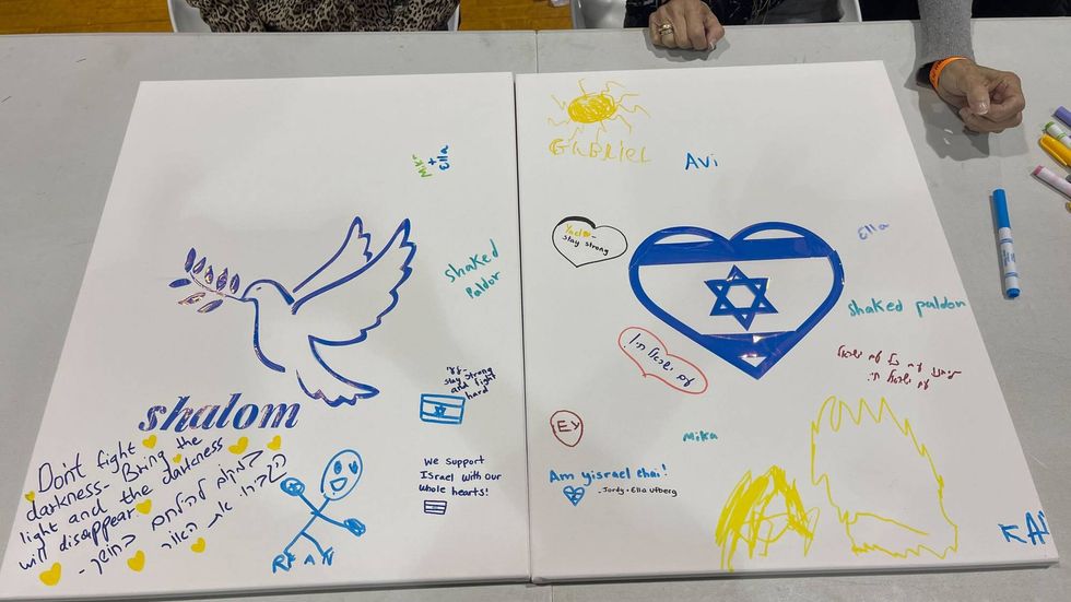 Attendees were encouraged to sign cards and canvasses with messages of support for people in the warzone.