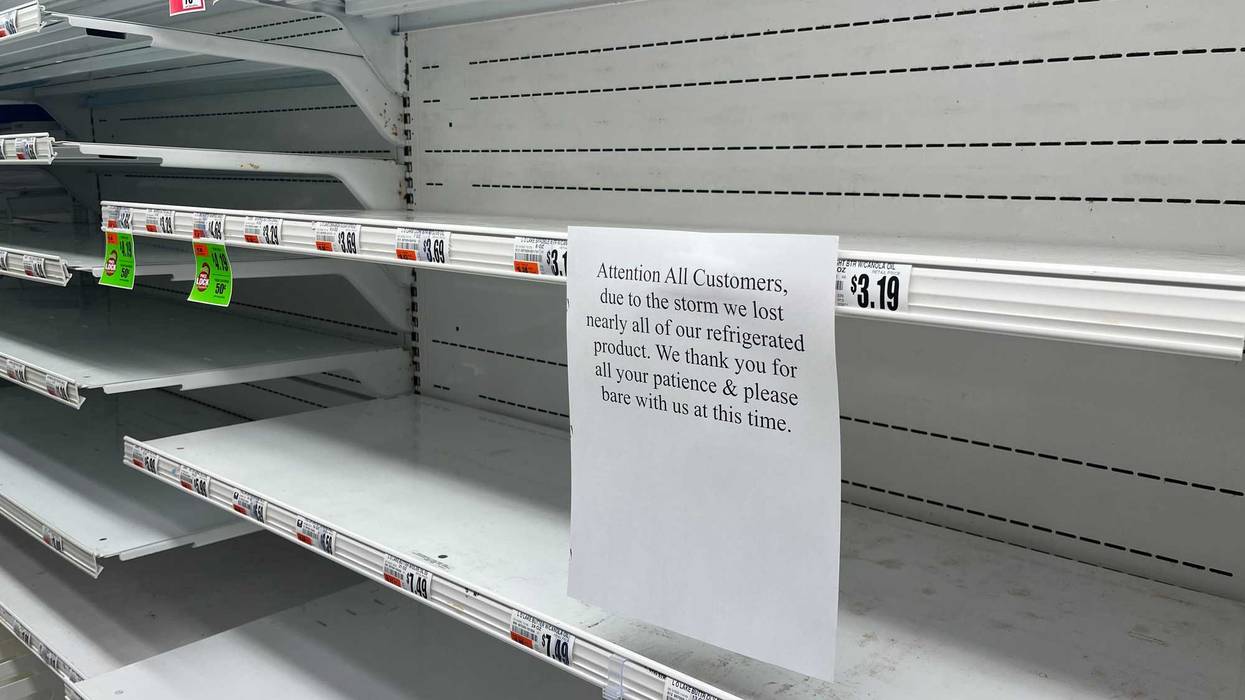 "Attention All Customers, due to the storm lost nearly all of our refrigerated product. We thank you for all your patience & please bare with us at this time." says the sign in the dairy section at the TOPS in Tonawanda.