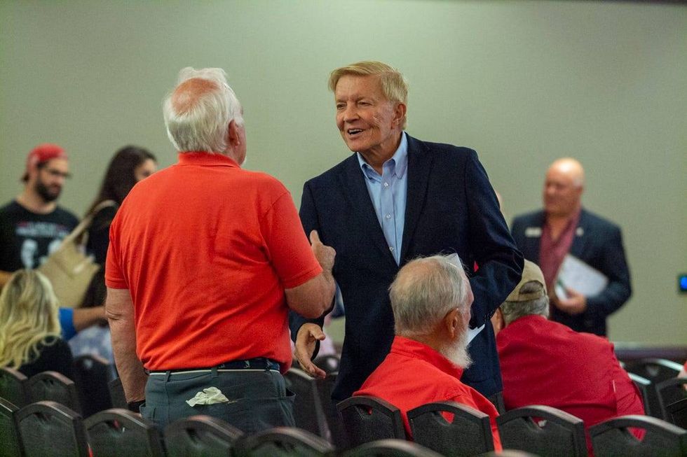 Attorney Bob Fioretti shakes hands at the Republican State Central Committee breakfast in Springfield. He