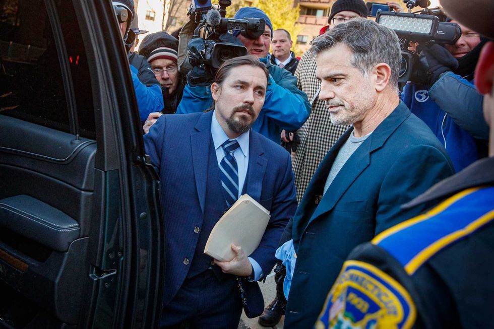 Attorney Kevin Miller, left, helps client Fotis Dulos enter a car outside Stamford Superior Court after Dulos was released on a $6-million bond on Jan. 9, 2020 in Samford, Conn.