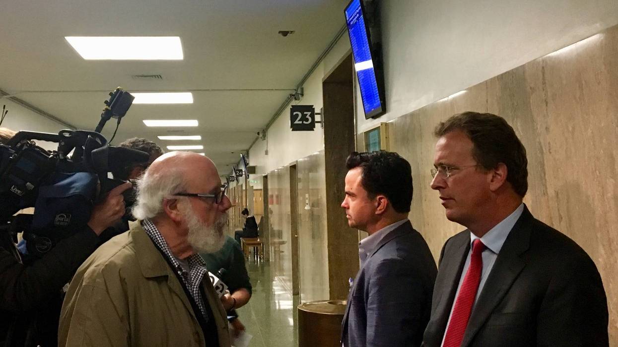 Attorney Thomas Burke, right, answers questions about his client Bryan Carmody, a freelance journalist whose home and office were raided by San Francisco police.
