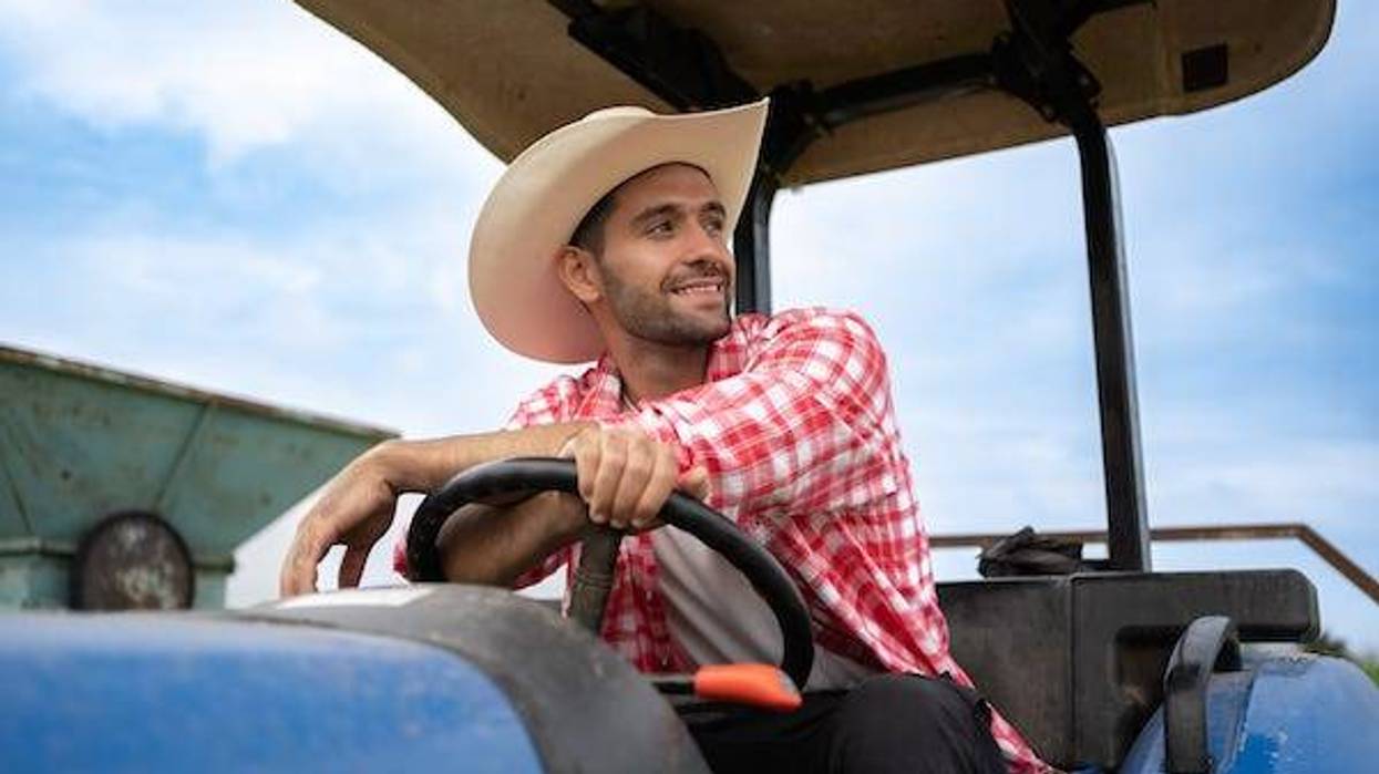 Attractive farmer sitting on a tractor