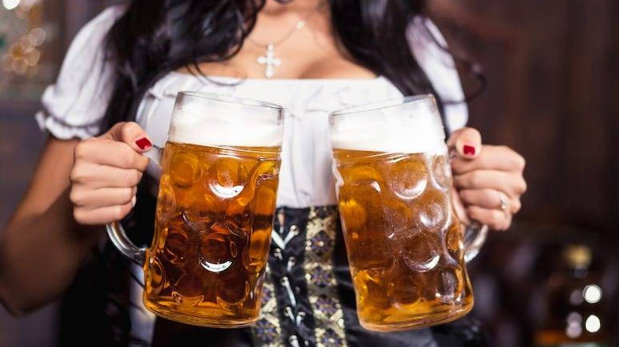 Attractive waitress carrying beer
