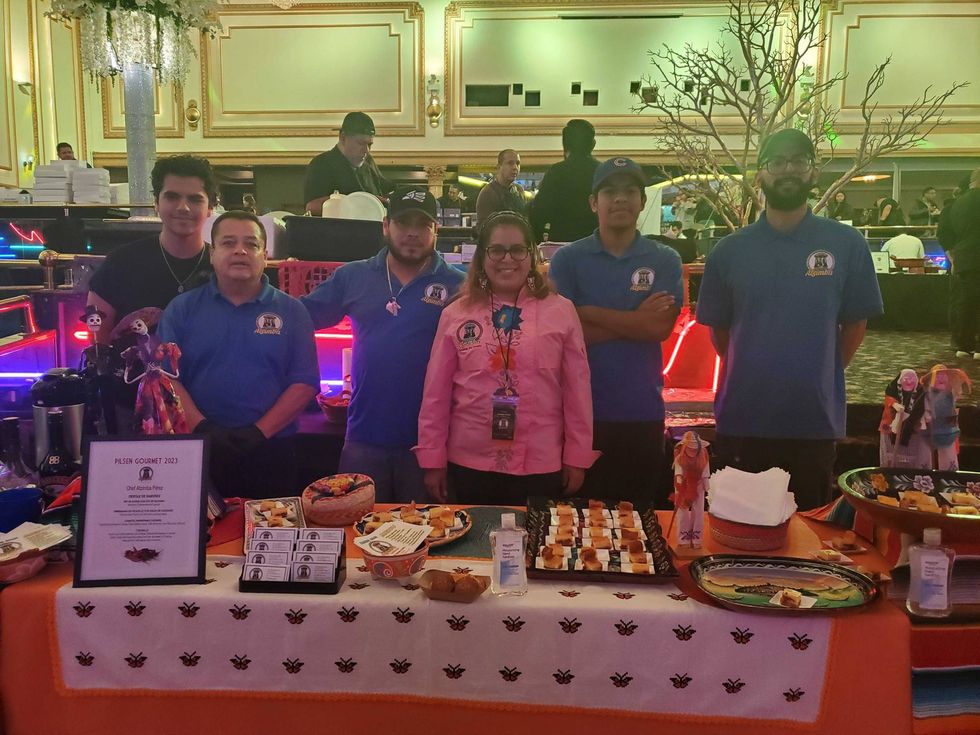 Atzimba Perez, owner and founder of Atzimba Catering, stands with her team at the Pilsen Gourmet Festival.