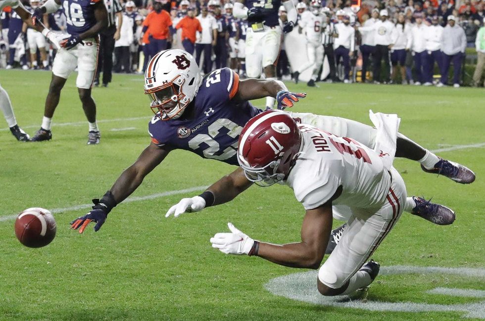 Auburn Tigers cornerback Roger McCreary (23) breaks up a pass intended for Alabama Crimson Tide wide receiver Traeshon Holden (11) during the third quarter at Jordan-Hare Stadium.