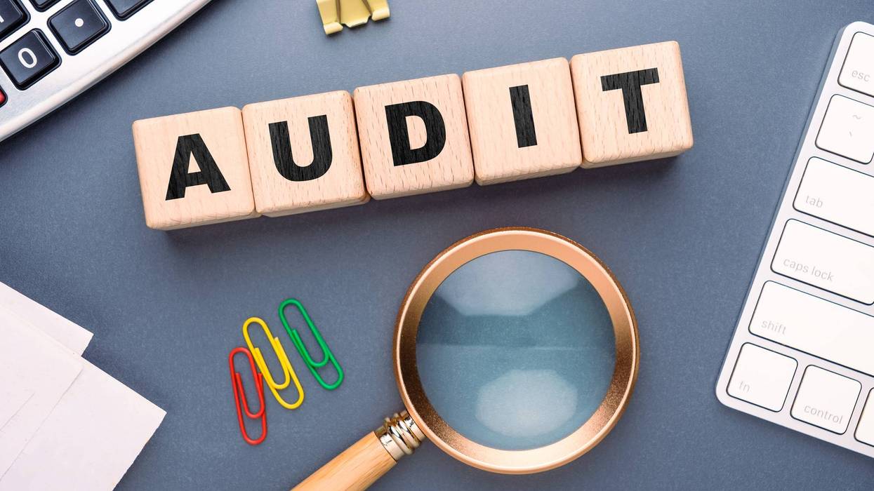 Audit concept with wooden blocks and office tools