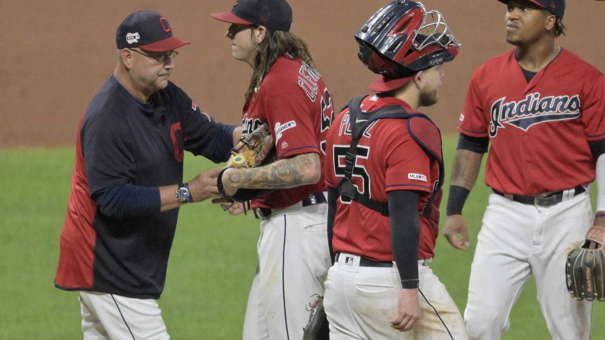 Aug 13, 2019; Cleveland, OH, USA; Cleveland Indians manager Terry Francona (77) takes the ball from starting pitcher Mike Clevinger (52) during a pitching change in the fifth inning against the Boston Red Sox at Progressive Field. Mandatory Credit: David