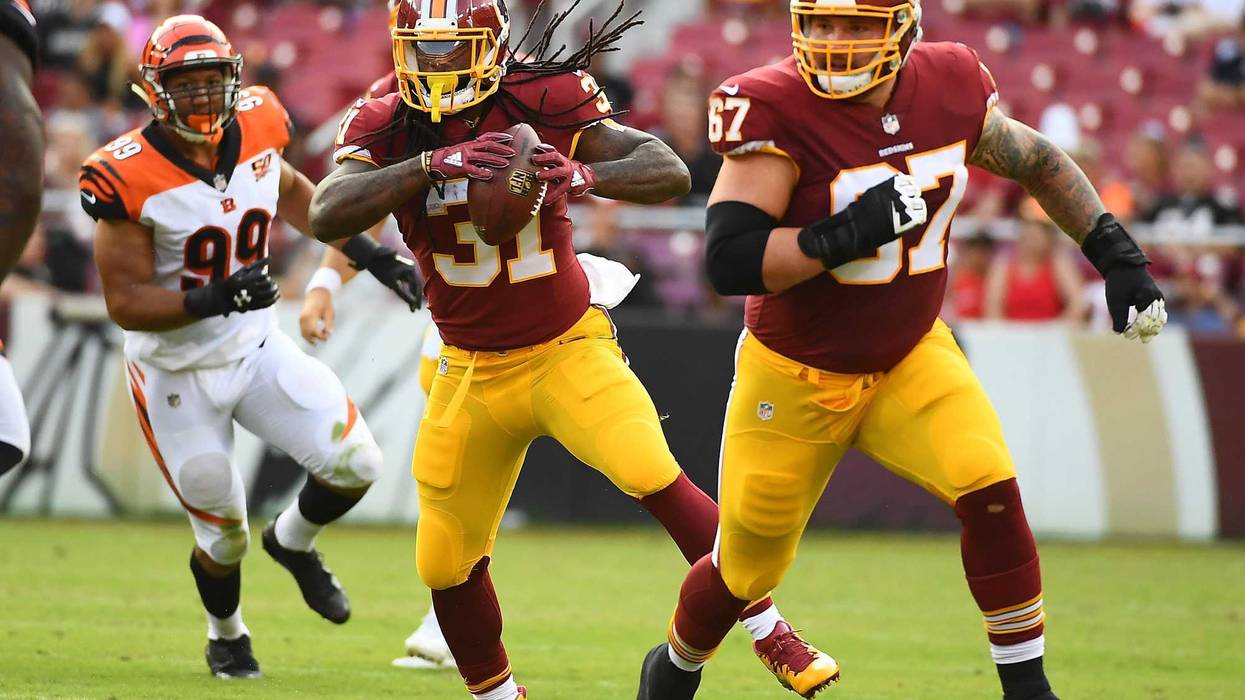 Aug 27, 2017; Landover, MD, USA; Washington Redskins running back Matt Jones (31) carries the ball as offensive guard Kyle Kalis (67) blocks against the Cincinnati Bengals during the second half at FedEx Field. Mandatory Credit: Brad Mills-USA TODAY Sport