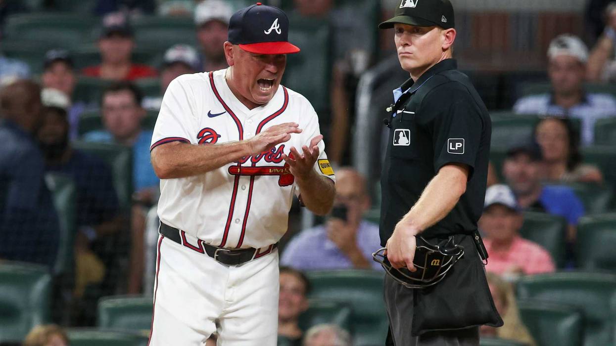 Aug 7, 2024; Atlanta, Georgia, USA; Atlanta Braves manager Brian Snitker (43) reacts to umpire Brian Walsh (120) after being ejected from a game against the Milwaukee Brewers in the fifth inning at Truist Park. Mandatory Credit: Brett Davis-USA TODAY Sports