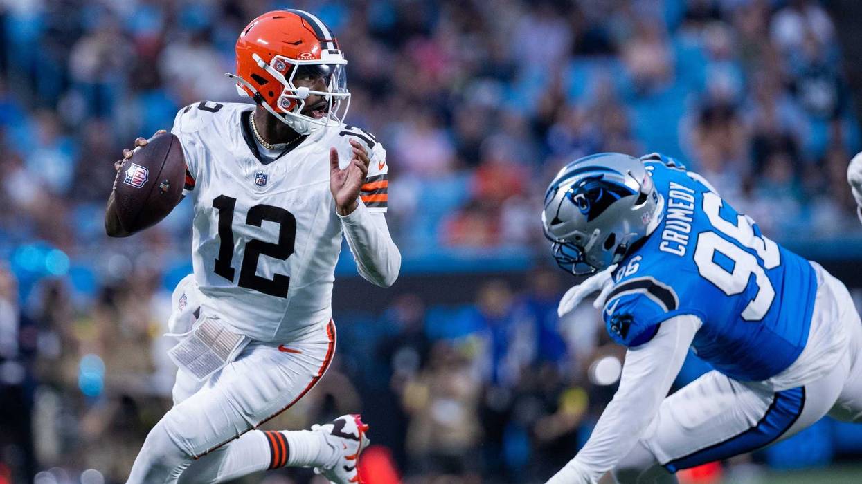 Aug 8, 2025; Charlotte, North Carolina, USA; Cleveland Browns quarterback Shedeur Sanders (12) gets away from Carolina Panthers defensive tackle Jaden Crumedy (96) during the second quarter at Bank of America Stadium.