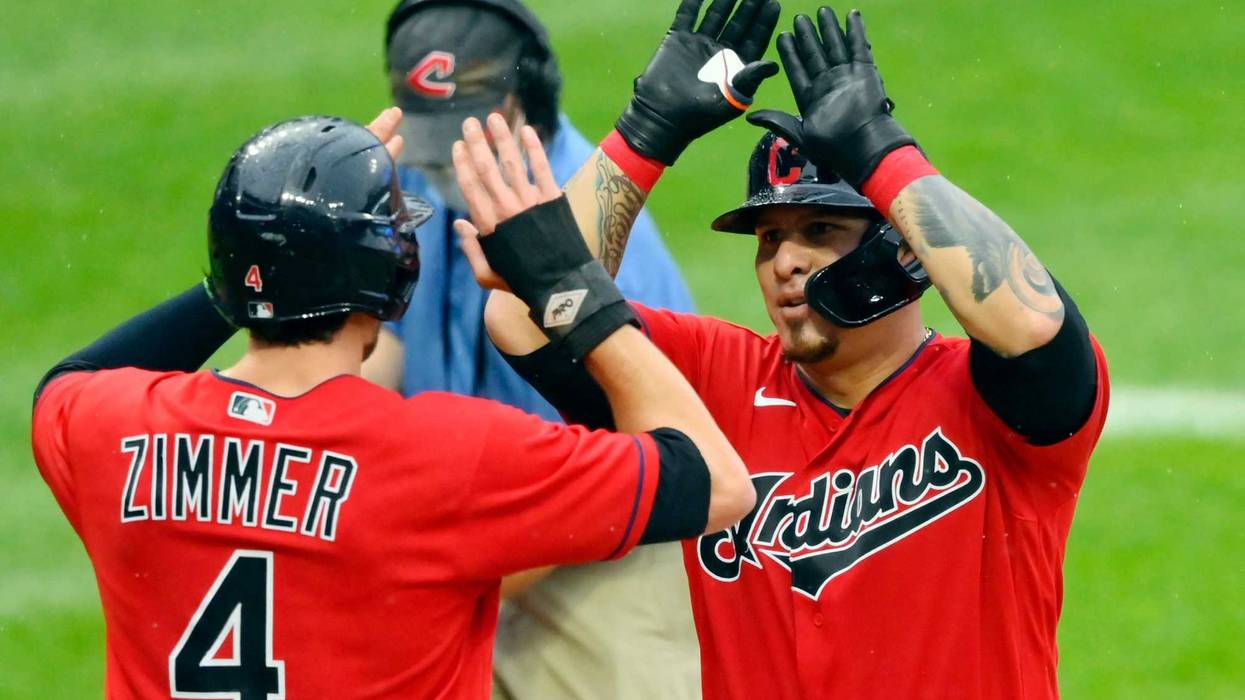 Aug 9, 2021; Cleveland, Ohio, USA; Cleveland Indians catcher Wilson Ramos (40) celebrates with right fielder Bradley Zimmer (4) after hitting a two-run home run against the Cincinnati Reds in the second inning at Progressive Field.