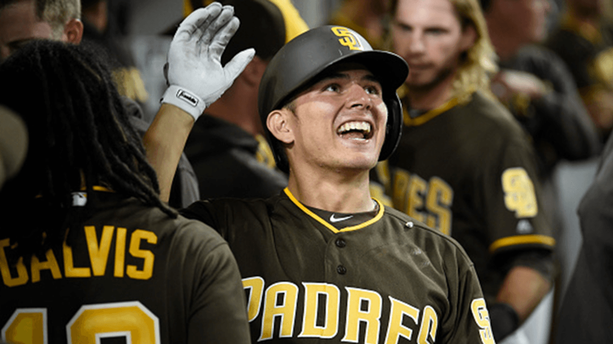 AUGUST 31: Luis Urias #9 of the San Diego Padres is congratulated after hitting a two-run home run during the eighth inning of a baseball game against the Colorado Rockies at PETCO Park on August 31, 2018 in San Diego, California. (Photo by Denis Poroy/Ge