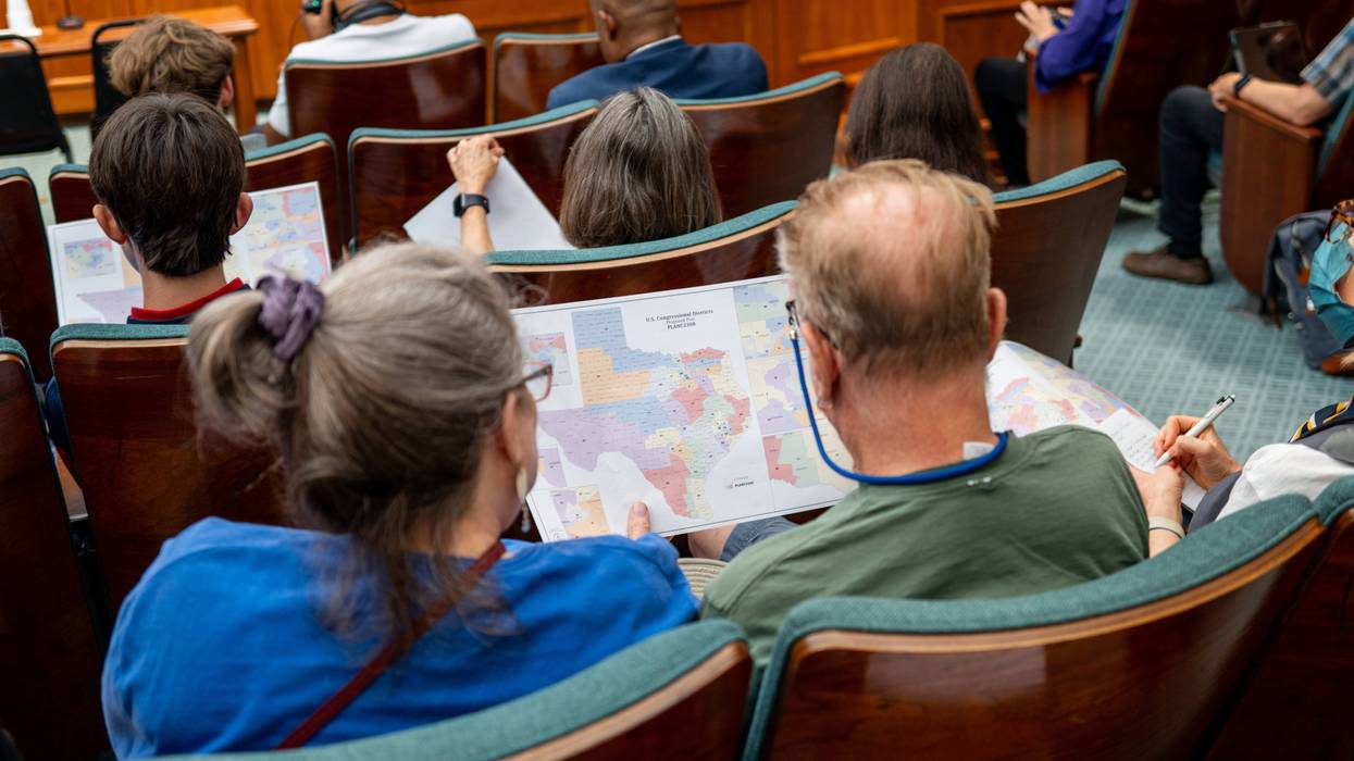 AUSTIN, TEXAS - AUGUST 07: Attendees view a map during a Senate Special Committee on Congressional Redistricting public testimony hearing on August 07, 2025 in Austin, Texas. The Senate Special Committee on Congressional Redistricting met to hear public testimony on Congressional plan C2308. Earlier this week, Texas Democratic lawmakers fled the state in an attempt to protest and deny quorum for votes on the proposed Republican redistricting plan, which would secure five additional GOP seats in the U.S. House. Gov. Greg Abbott has threatened to remove lawmakers who do not return and has asked the Texas Supreme Court to expel House Democratic leaders who fled the state. (Photo by Brandon Bell/Getty Images)