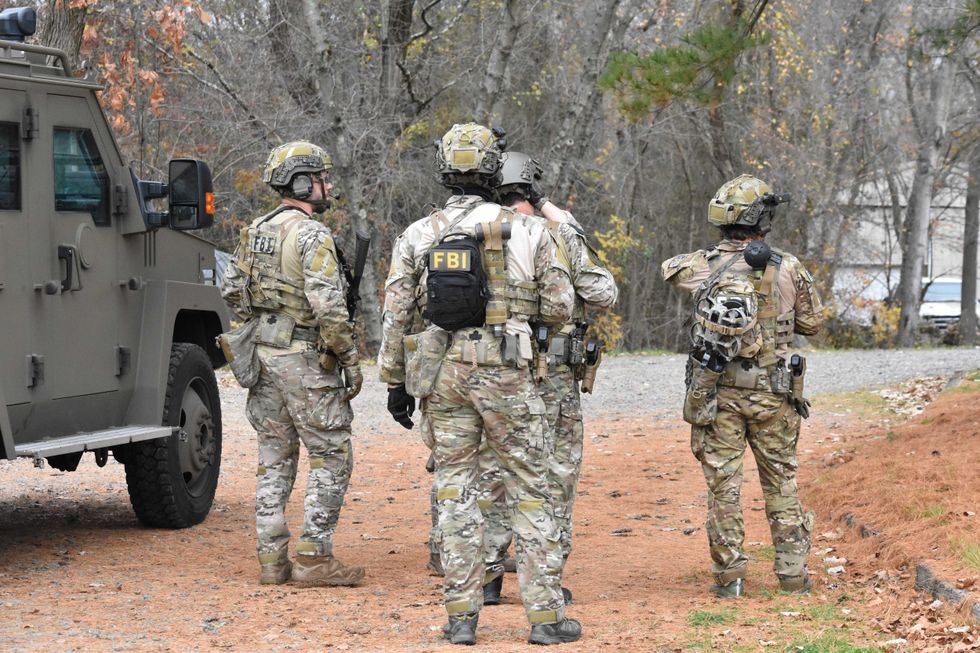 Authorities converge on the home owned by Gregory Yetman on Thursday