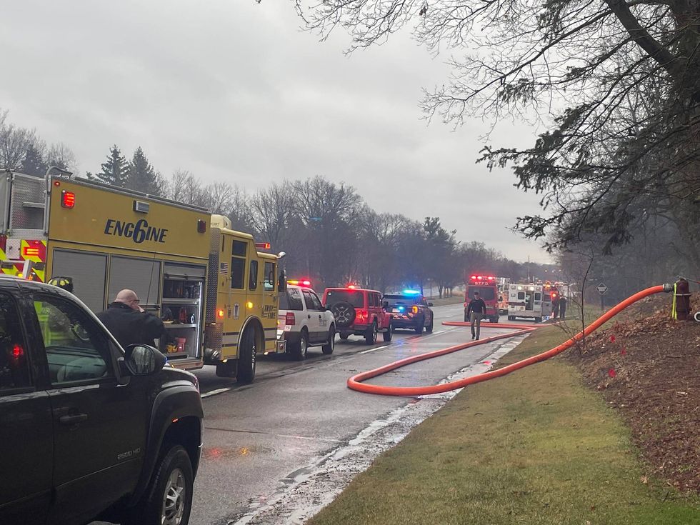 Authorities warned traffic will be slow moving along Woodward Ave. in Bloomfield Hills as crews work to control a fire that broke out at a condominium late Friday morning.