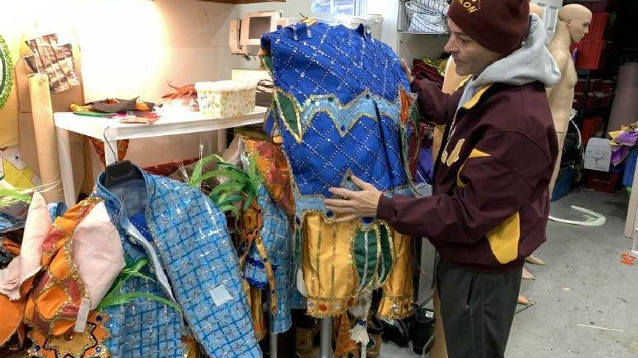Avalon String Band costume coordinator Jimmy Tatar takes a final look at the band’s outfits for the Mummers parade.