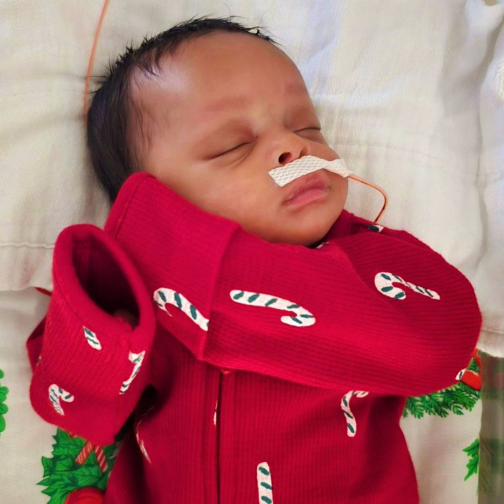 Baby in candy cane onesie