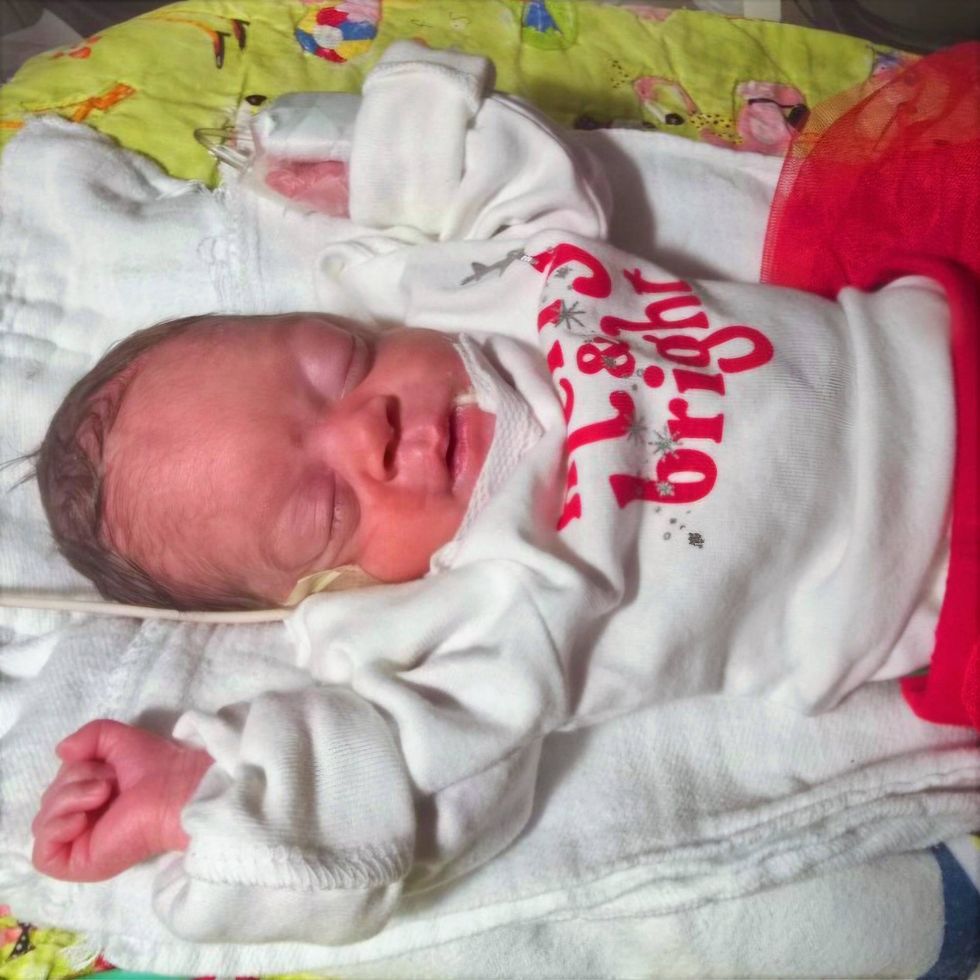 Baby with "Merry & Bright" onesie