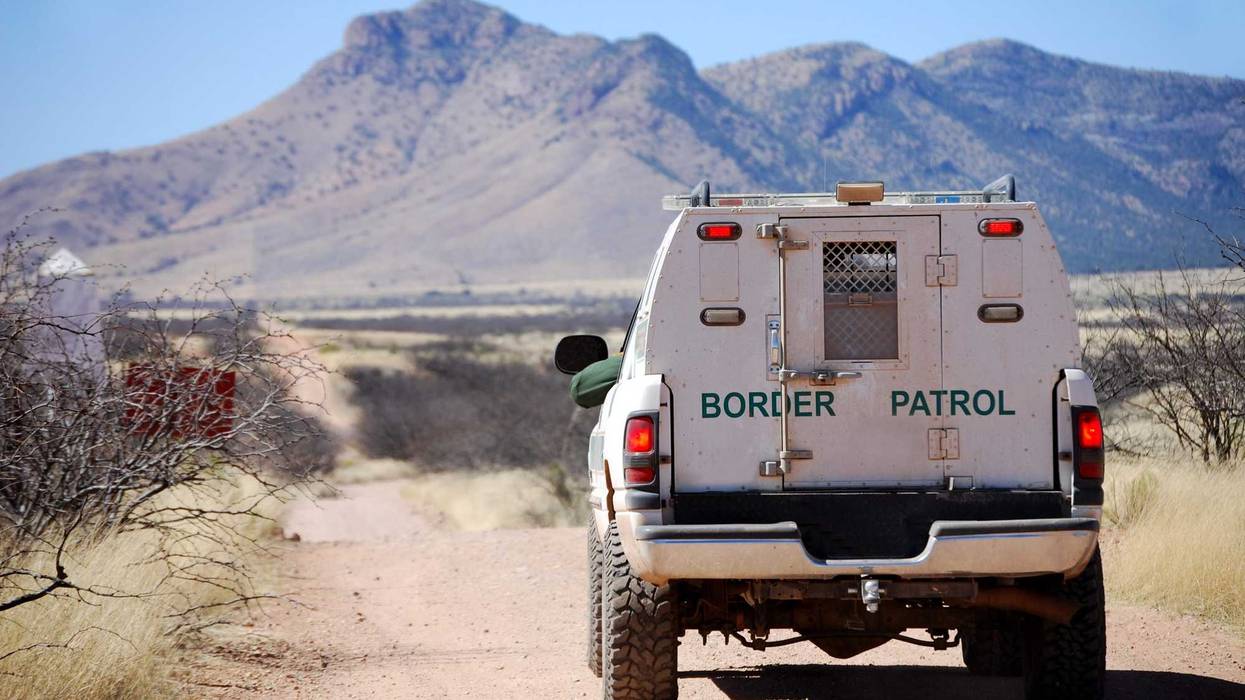Back of a border patrol truck driving on a dirt road along the Mexican border in Arizona