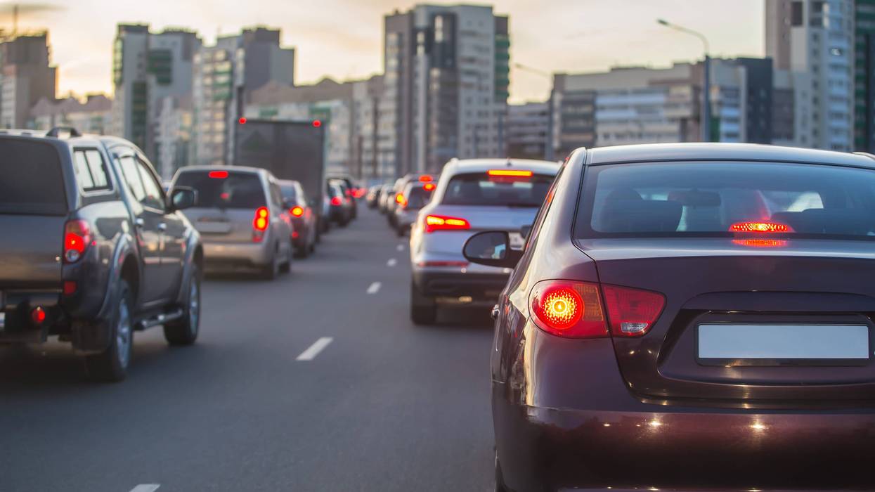 Back of cars driving on road