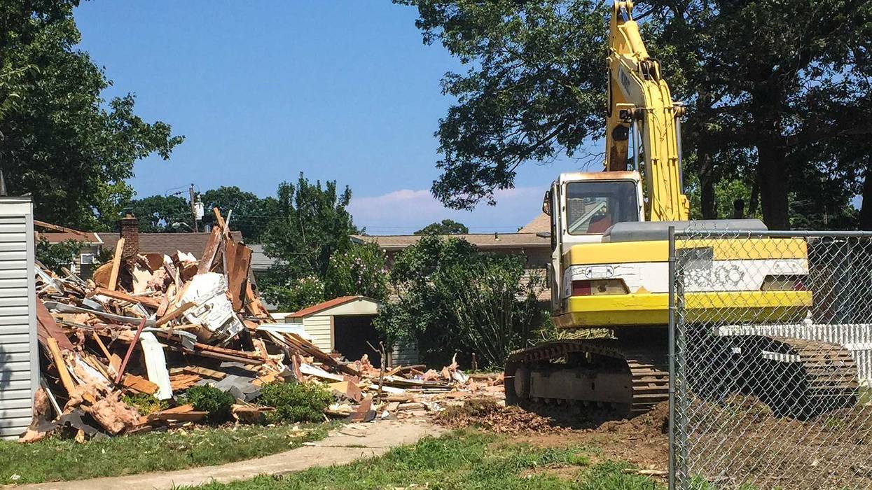 backhoe on demolished property