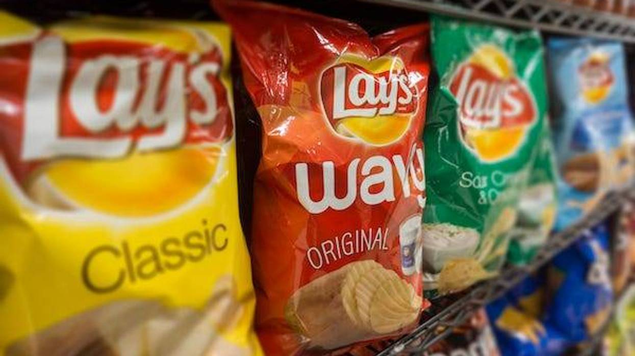 Bags of Lay's potato chips on a store shelf