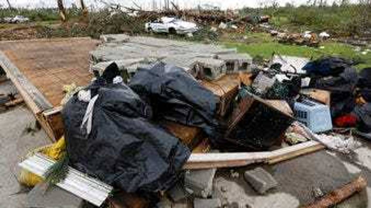 Bags of recovered clothing rest on what remains of the floor in Mama D's Bar and Grill in Bassfield, Miss., Monday, April 13, 2020. (AP Photo/Rogelio V. Solis)