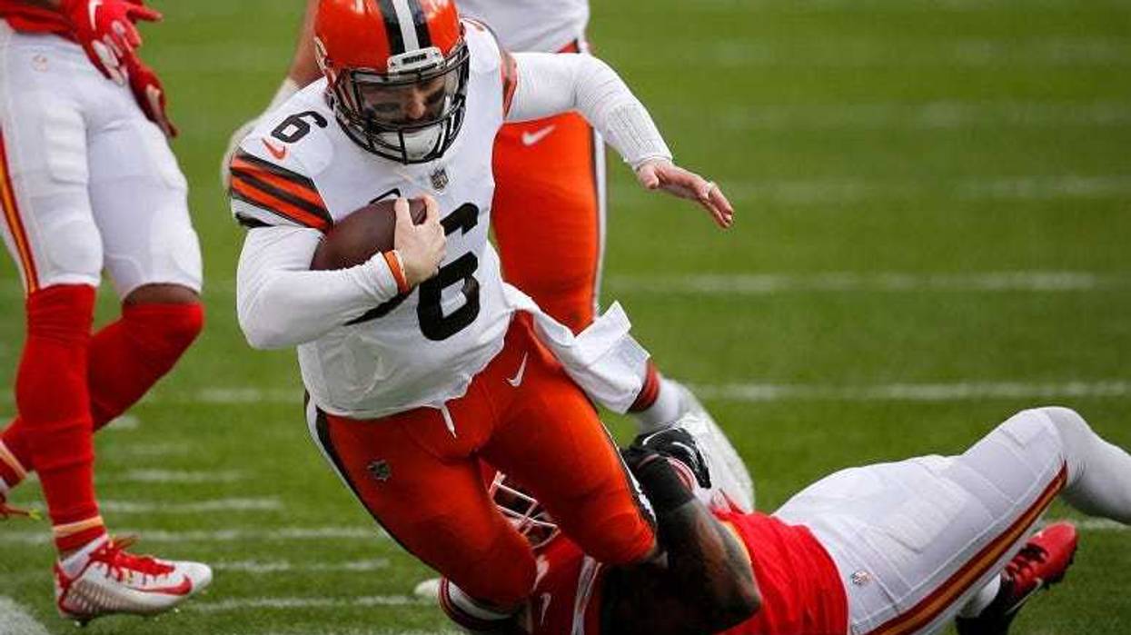Baker Mayfield is sacked by middle linebacker Anthony Hitchens during the first quarter of the AFC Divisional Playoff game