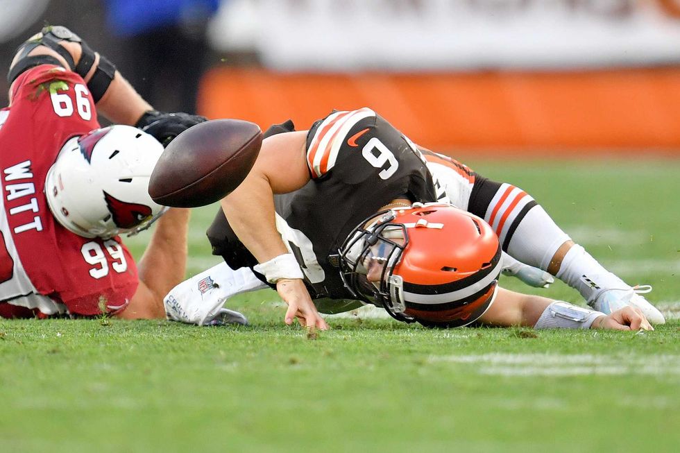 Baker Mayfield of the Cleveland Browns fumbles the ball after a tackle from J.J. Watt of the Arizona Cardinals