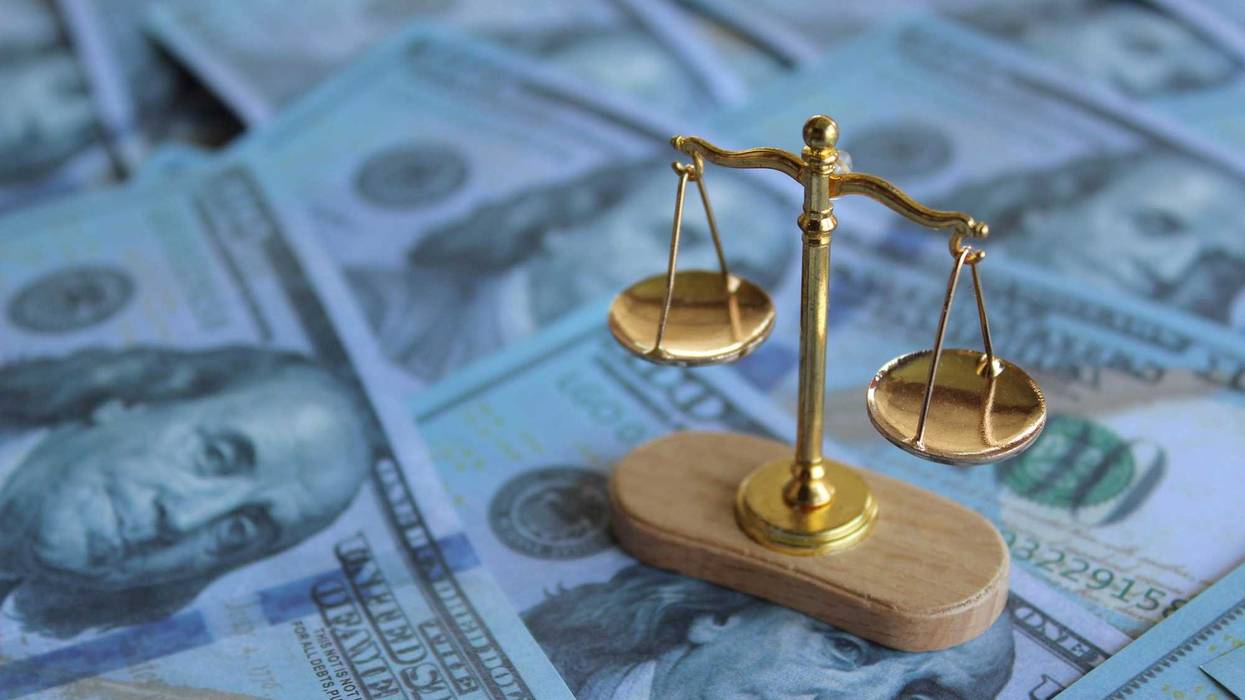 Balancing scale on top of money. Law, bribery, justice and corruption concept