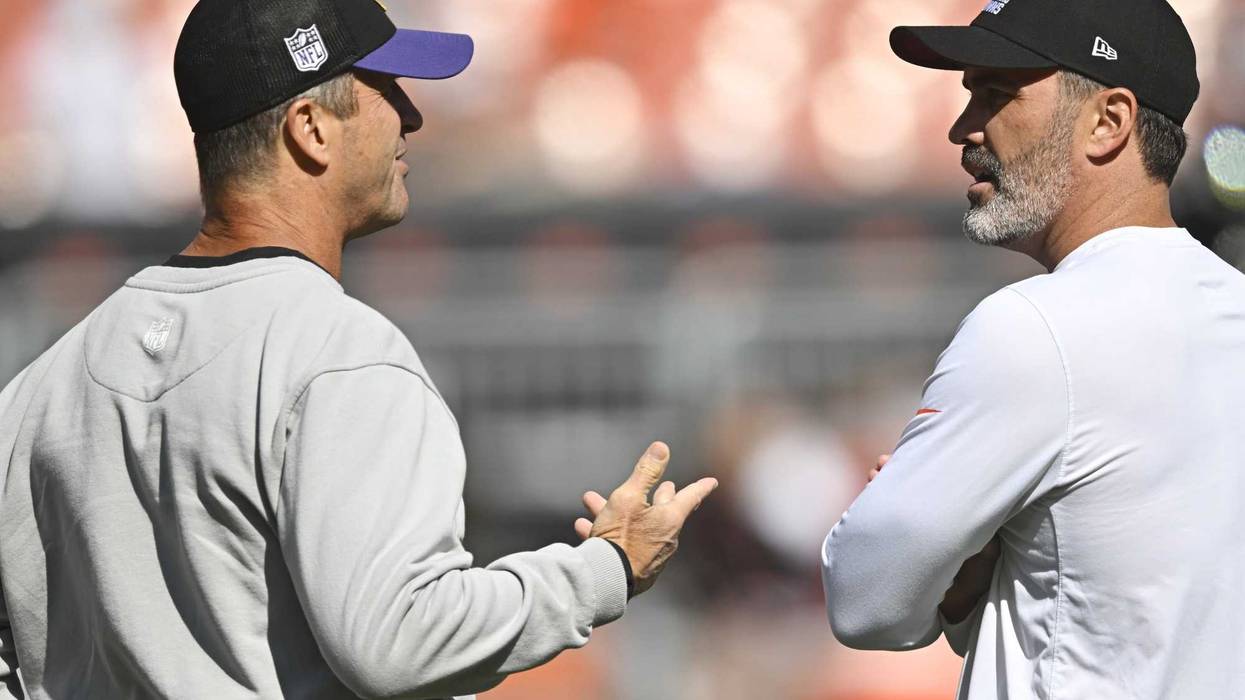 Baltimore Ravens head coach John Harbaugh (left) talks with Cleveland Browns head coach Kevin Stefanski.