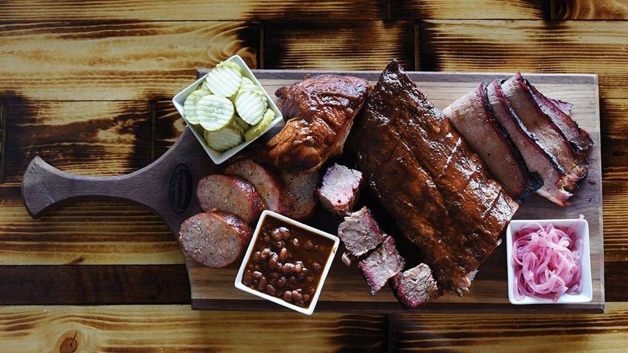 Barbecue meats and other food served on a cold cut board