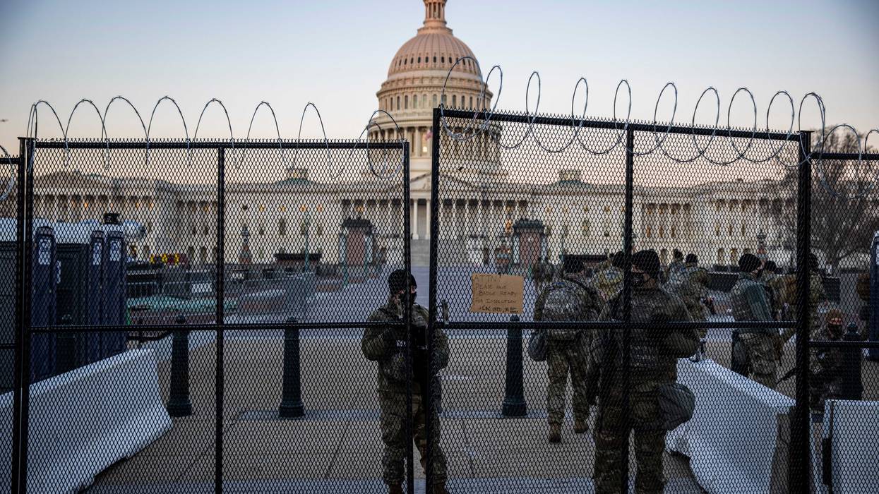 Barbed wire fences and National Guard troops surround the U.S. Capitol since the Jan. 6 attack by followers of then-President Donald Trump.