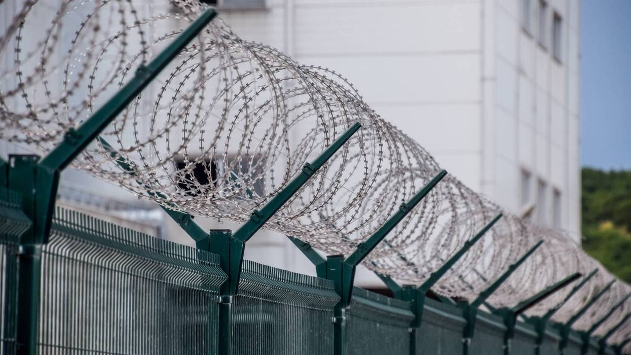 barbed wire surrounding prison exterior