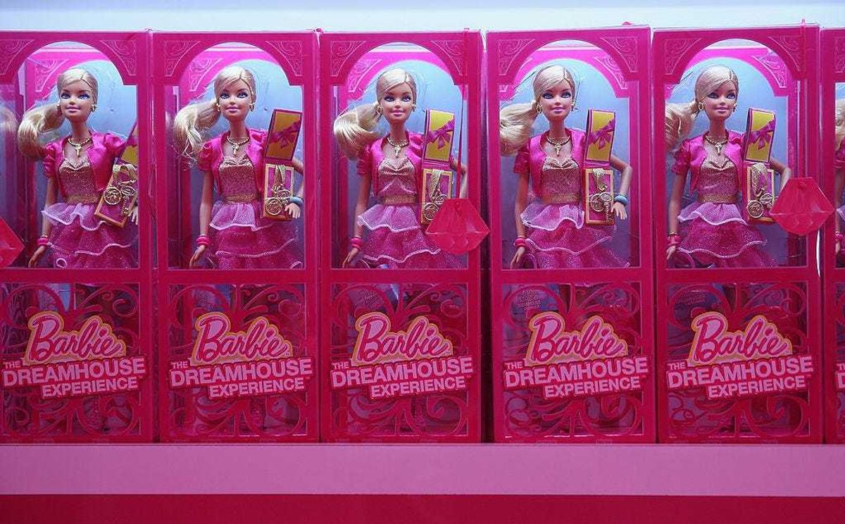 Barbie dolls and other souvenirs line shelves at the merchandising shop at the Barbie Dreamhouse Experience on May 16, 2013 in Berlin, Germany.