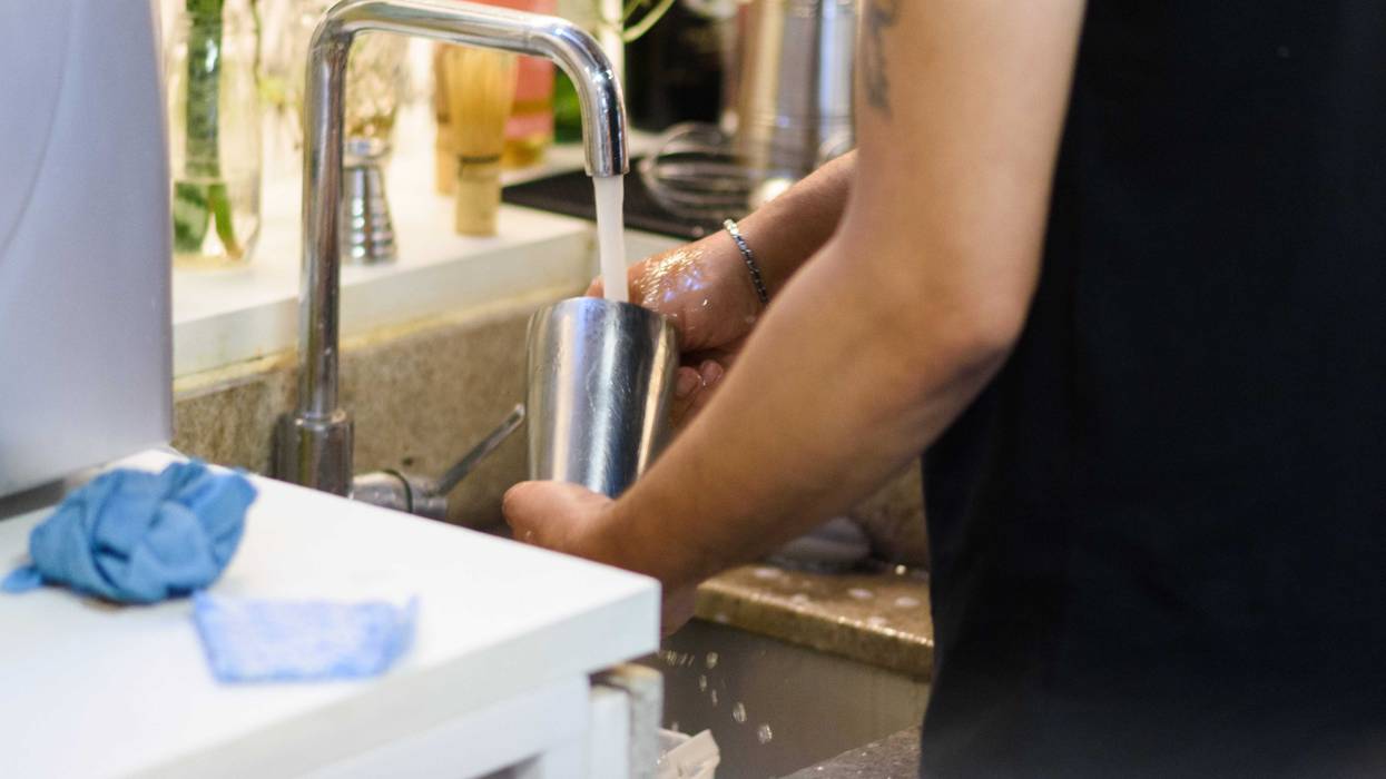 Barista washing metal cup