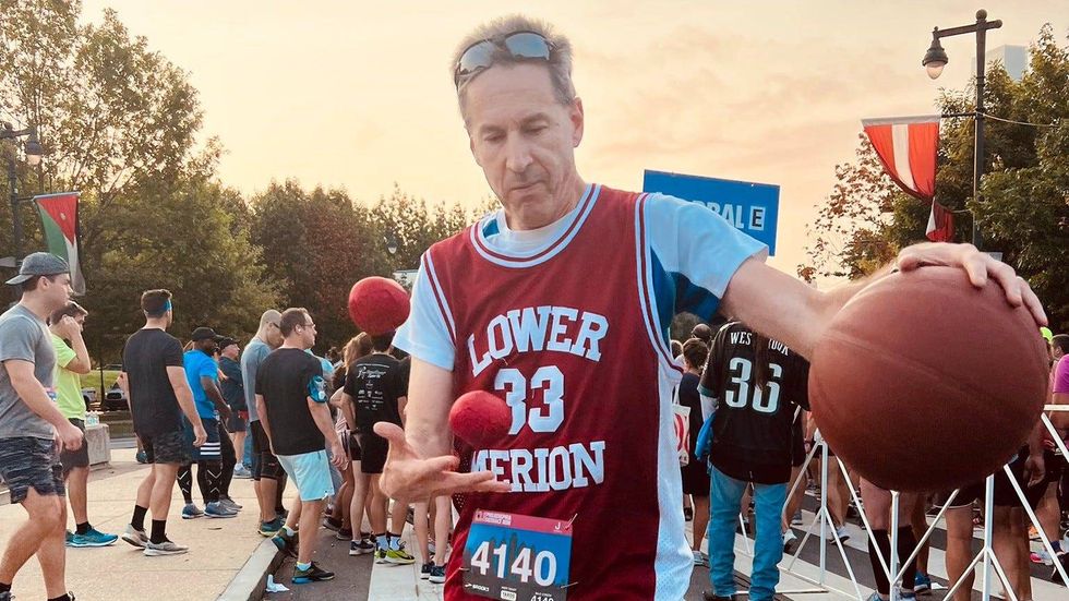 Barry Goldmeier, from Rockville, Maryland, juggled and dribbled as he ran the 2022 Philadelphia Distance Run on Sunday, Sept. 18.
