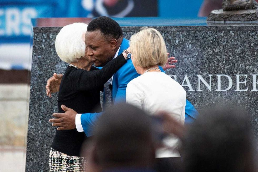 Barry Sanders hugs Detroit Lions owner and chair emeritus Martha Ford during the ceremony to unveil the statue outside of Ford Field in Detroit on Saturday, Sept. 16, 2023.