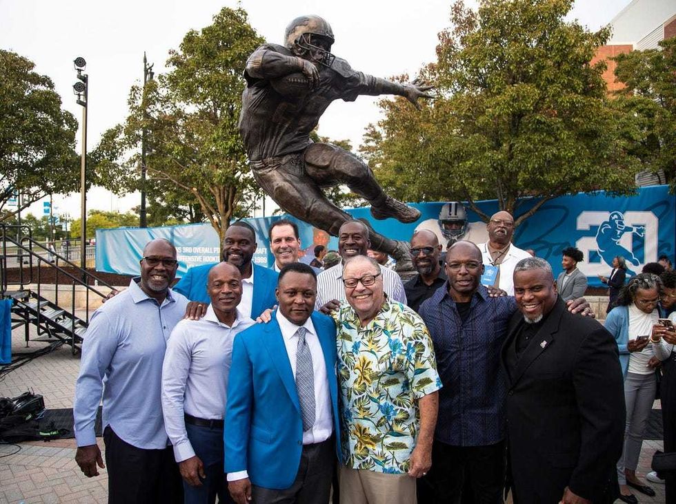Barry Sanders next to his former Lions coach Wayne Fontes and former teammates during the ceremony to unveil his statue outside of Ford Field in Detroit on Saturday, Sept. 16, 2023.