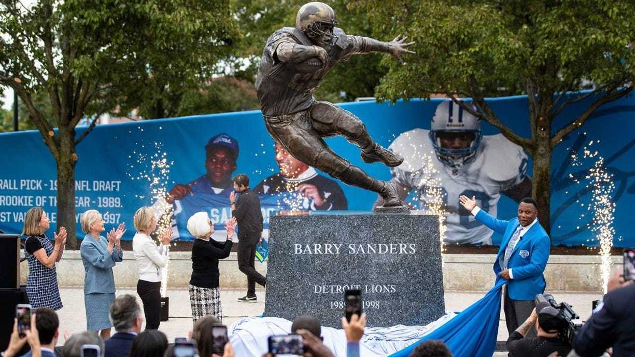 Barry Sanders, right, along with Detroit Lions owner and chair emeritus Martha Ford and principal owner and chair Shiela Ford Hamp unveil the statue outside of Ford Field in Detroit on Saturday, Sept. 16, 2023.