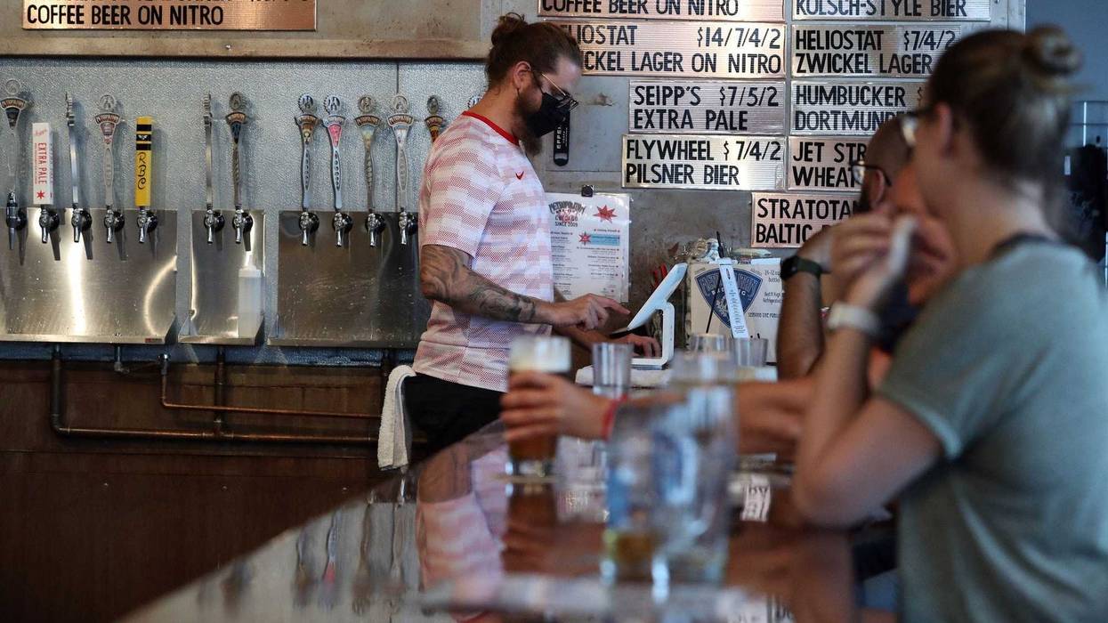 Bartender Marty Tomszak, left, pours a beer at Metropolitan Brewing taproom, on Aug. 10, 2021.