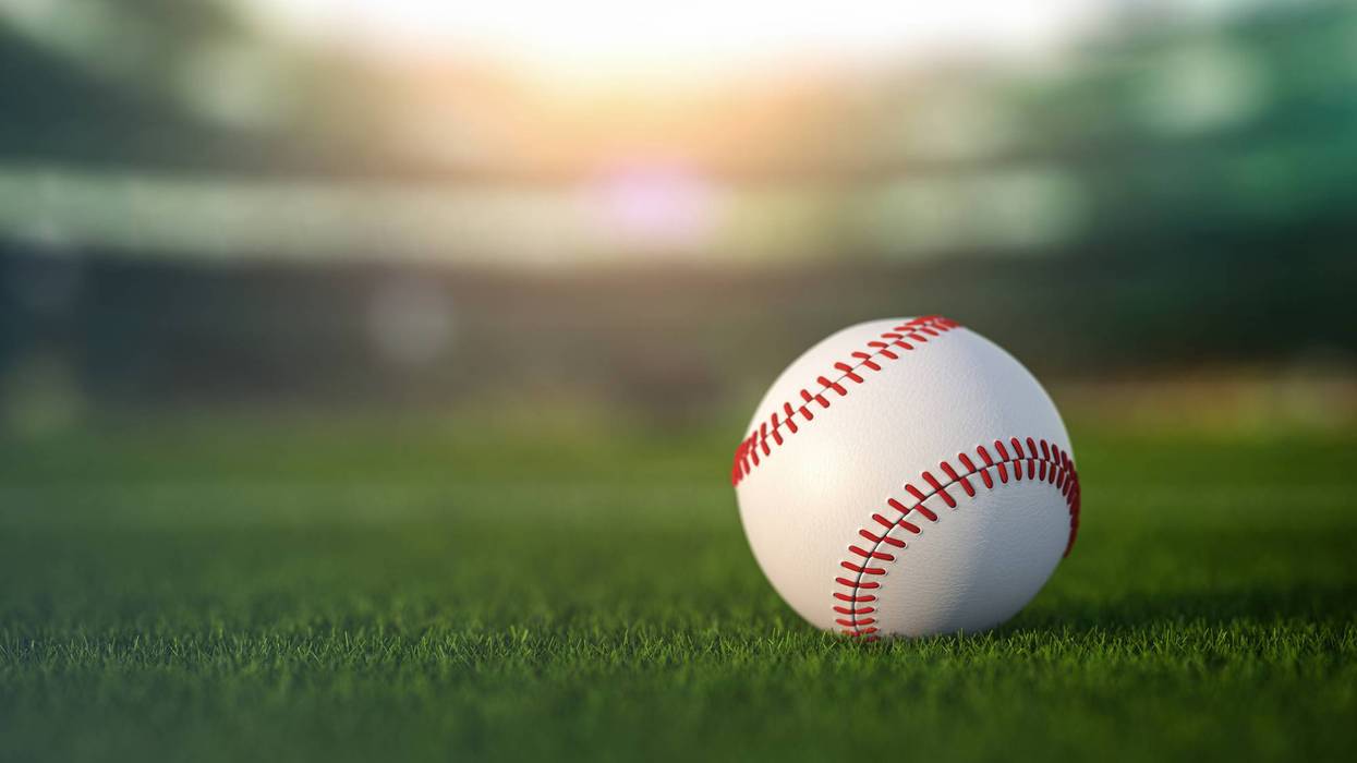 Baseball ball in a grass of baseball arena stadium.