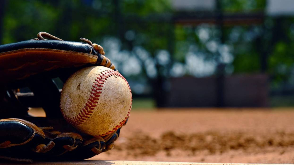 Baseball in glove on team field