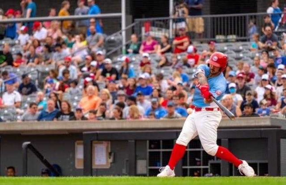 Baseball player swings at a pitch