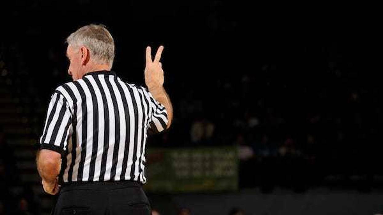 Basketball referee making hand sign