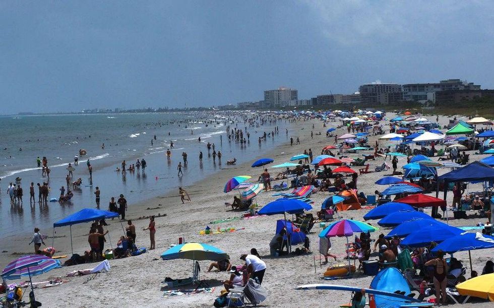 Beachgoers celebrate Independence Day on July 4th in Cocoa Beach, Florida